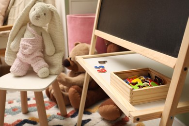 Photo of Different toys and furniture in child room