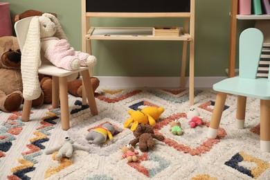 Stylish child room interior with different toys and furniture