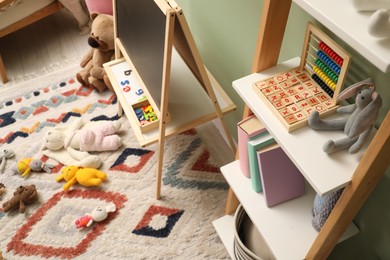 Photo of Stylish child room interior with different toys and furniture, above view