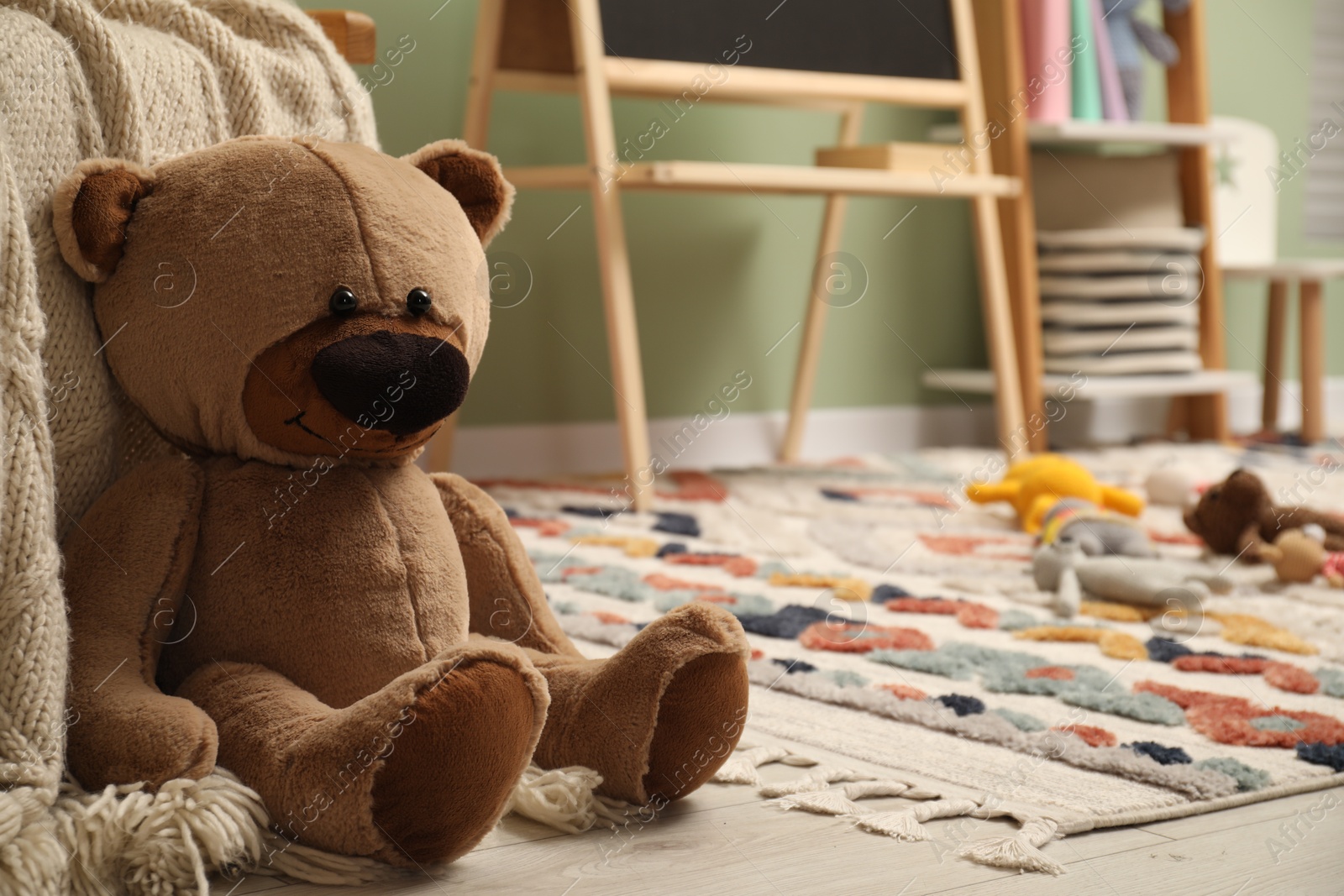 Photo of Teddy bear on floor in child room