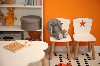 Photo of Stylish child room interior with different toys and furniture