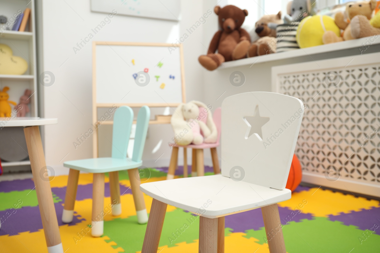 Photo of Stylish child room interior with different toys and furniture