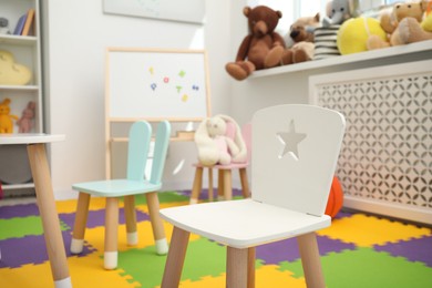 Stylish child room interior with different toys and furniture