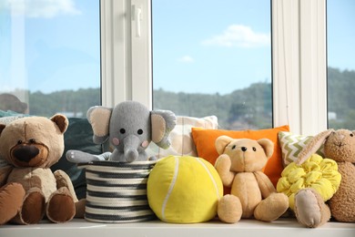 Photo of Different toys on windowsill in child room