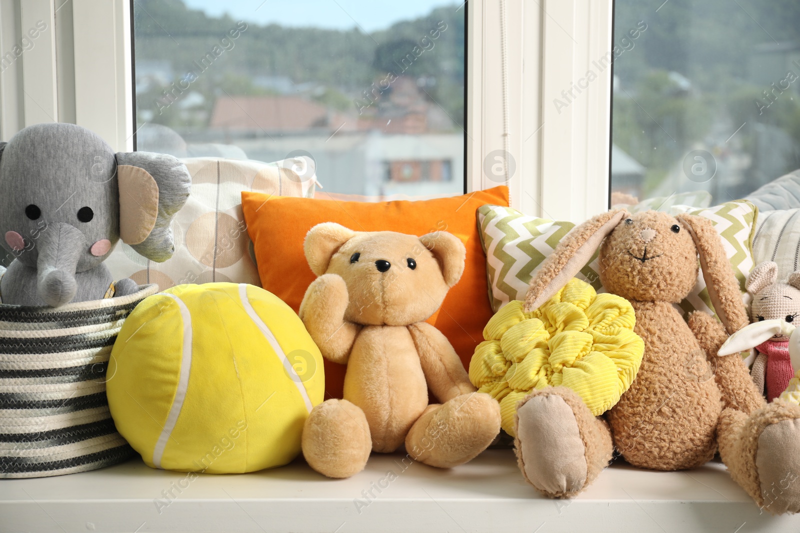 Photo of Different toys on windowsill in child room