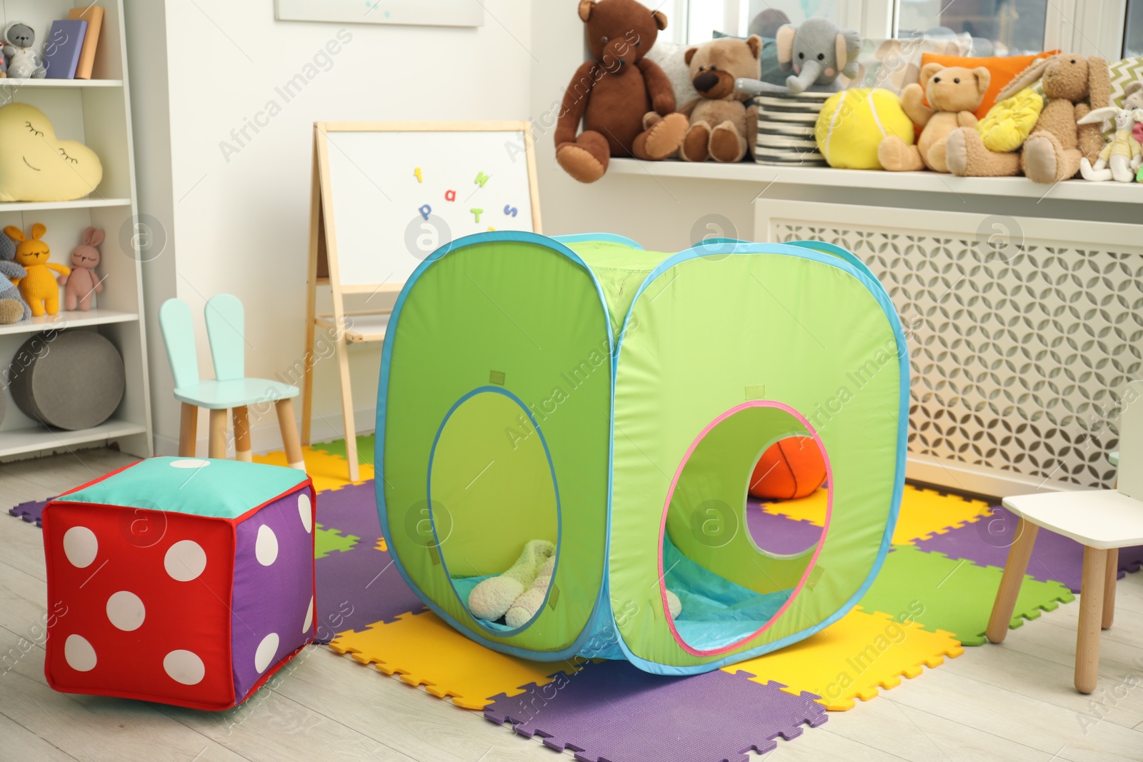 Photo of Stylish child room interior with different toys and furniture