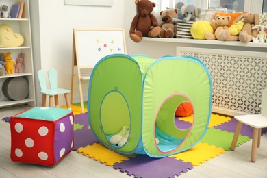 Stylish child room interior with different toys and furniture