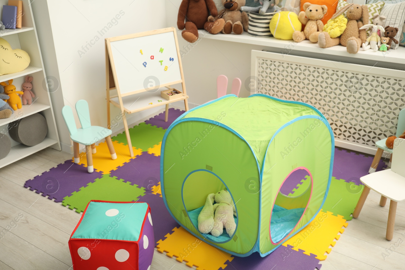 Photo of Stylish child room interior with different toys and furniture