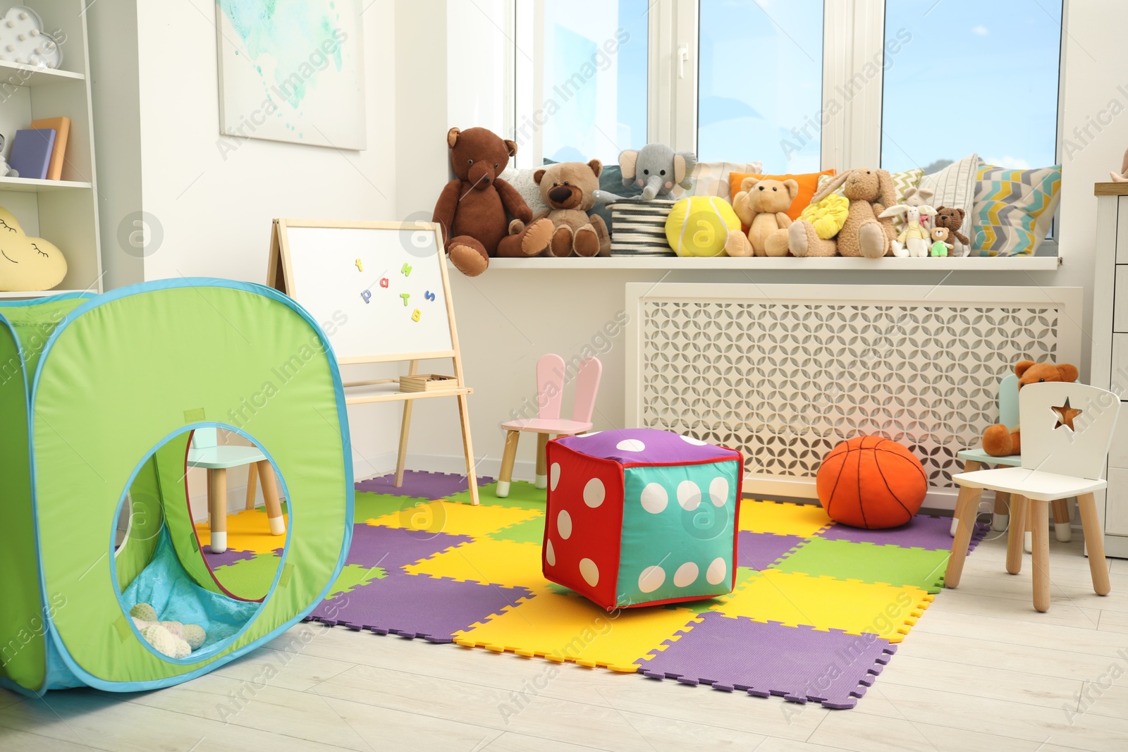 Photo of Stylish child room interior with different toys and furniture