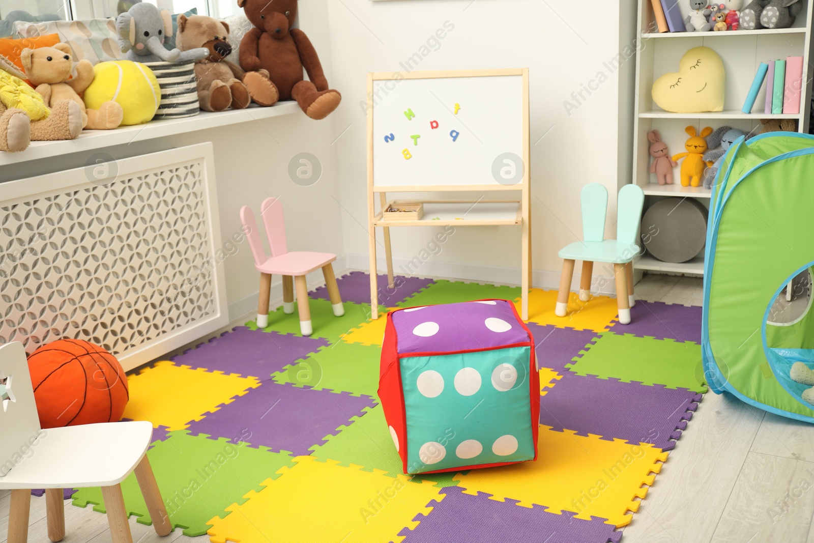 Photo of Stylish child room interior with different toys and furniture