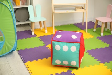 Photo of Stylish child room interior with furniture and colorful rug