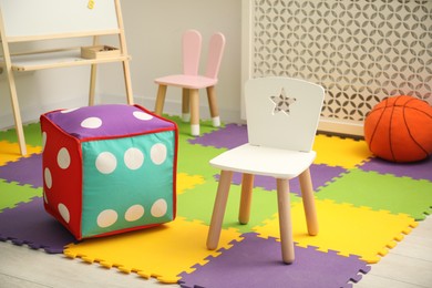 Photo of Stylish child room interior with different toys and furniture