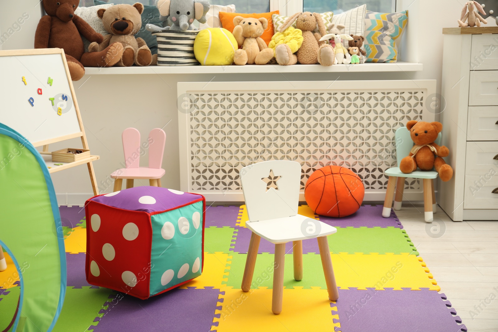 Photo of Stylish child room interior with different toys and furniture