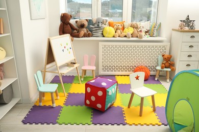 Stylish child room interior with different toys and furniture