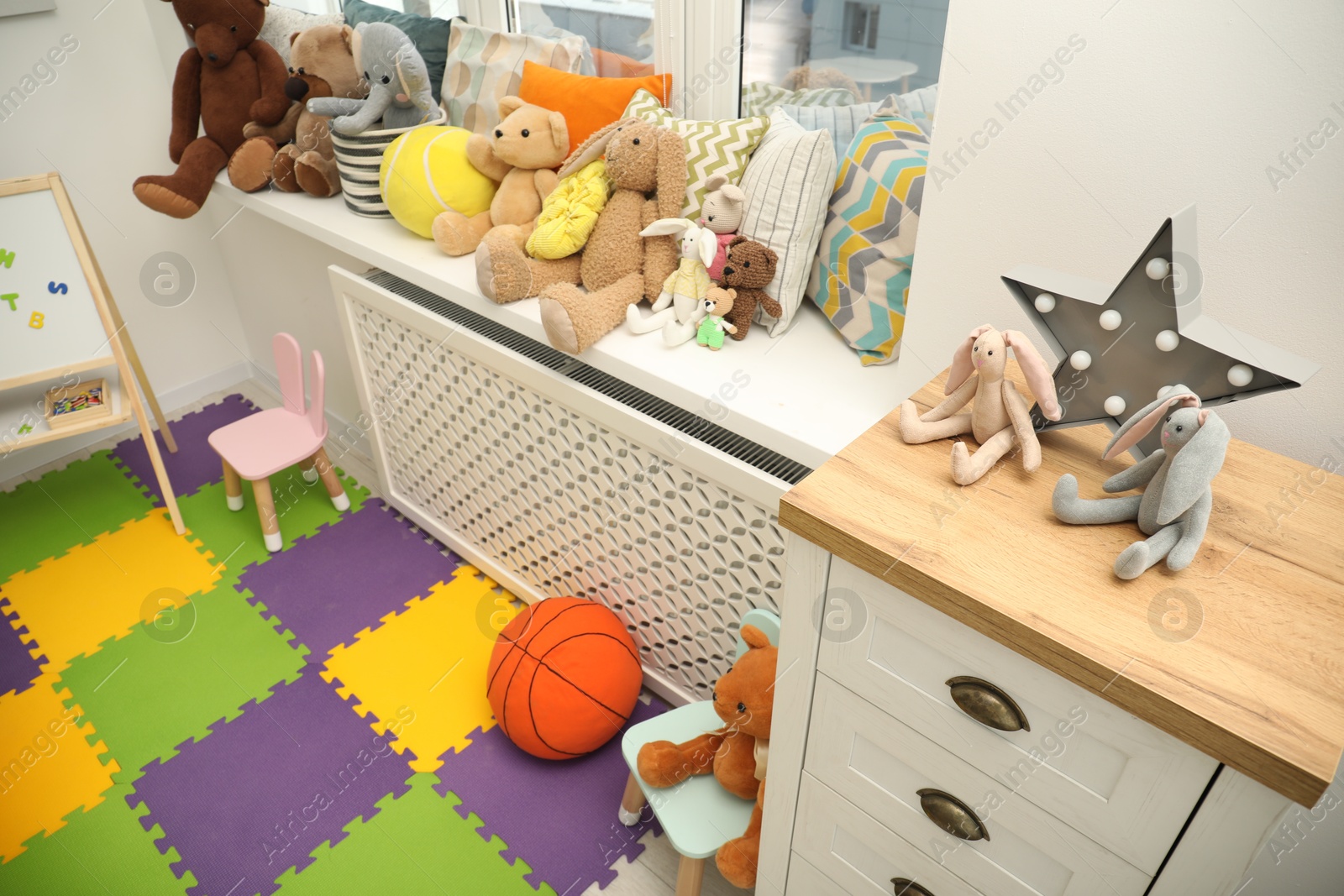 Photo of Different toys and furniture in child room