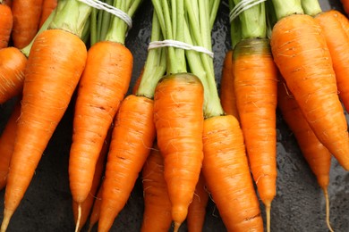 Tasty ripe juicy carrots on table, top view