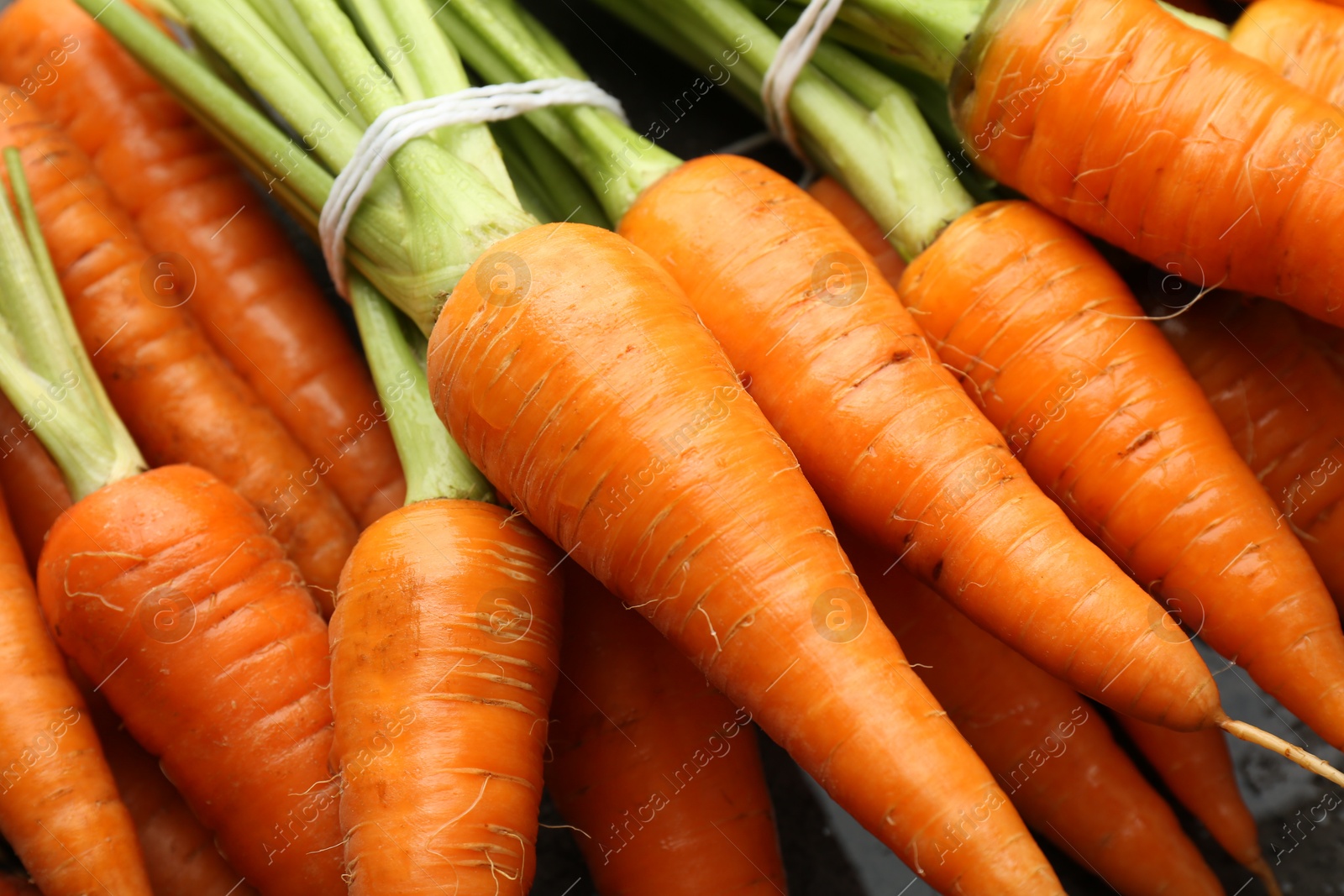 Photo of Tasty ripe juicy carrots on table, closeup