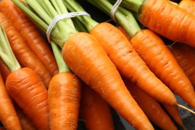 Tasty ripe juicy carrots on table, closeup