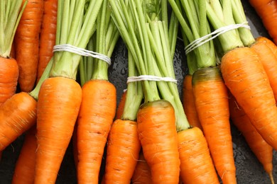 Photo of Tasty ripe juicy carrots on table, top view