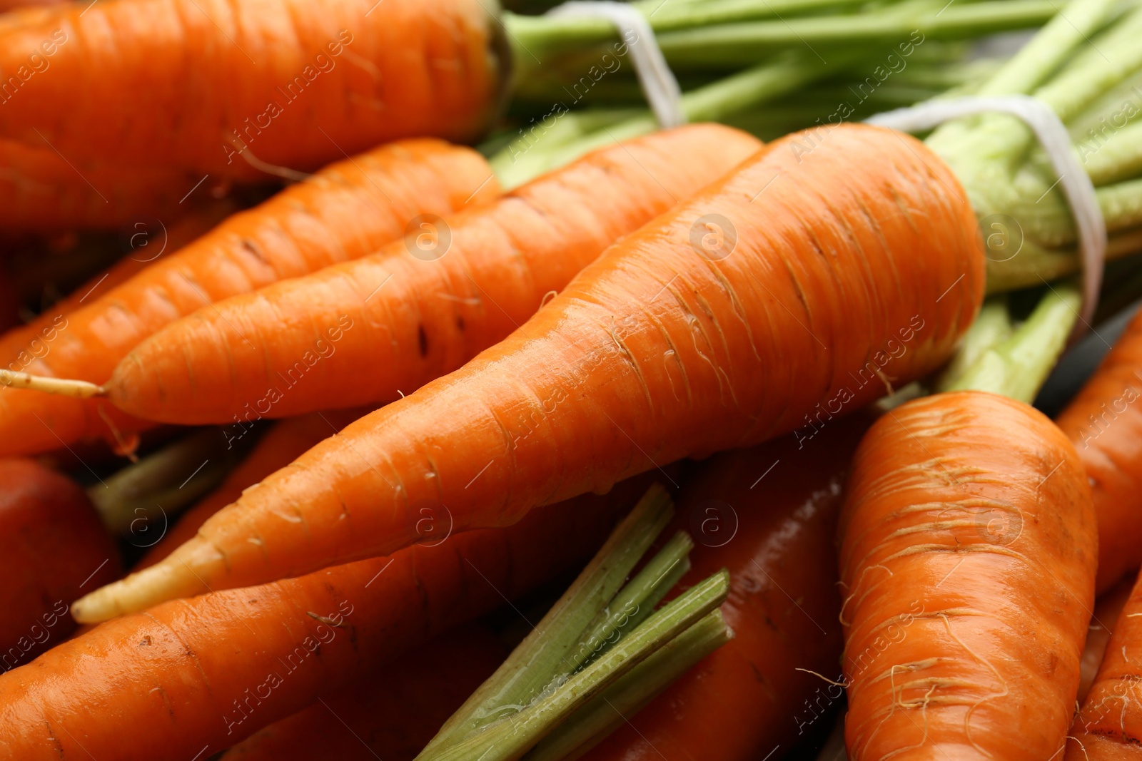 Photo of Tasty ripe juicy carrots as background, closeup