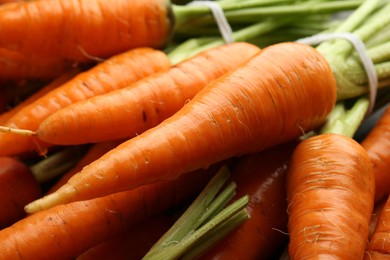 Tasty ripe juicy carrots as background, closeup