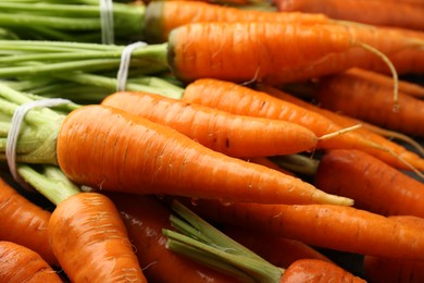 Tasty ripe juicy carrots as background, closeup