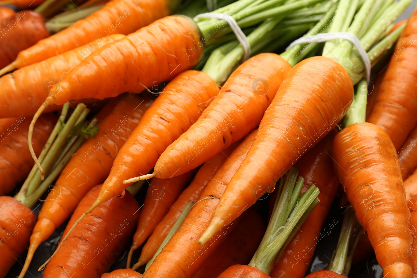 Photo of Tasty ripe juicy carrots on table, closeup