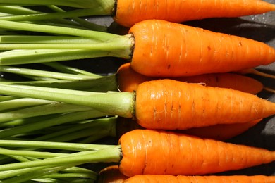 Tasty ripe juicy carrots on table, closeup