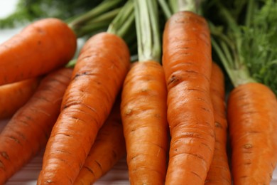 Tasty ripe juicy carrots on table, closeup