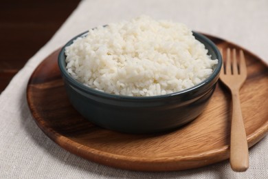 Photo of Delicious boiled rice in bowl on table