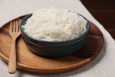 Delicious boiled rice in bowl on table