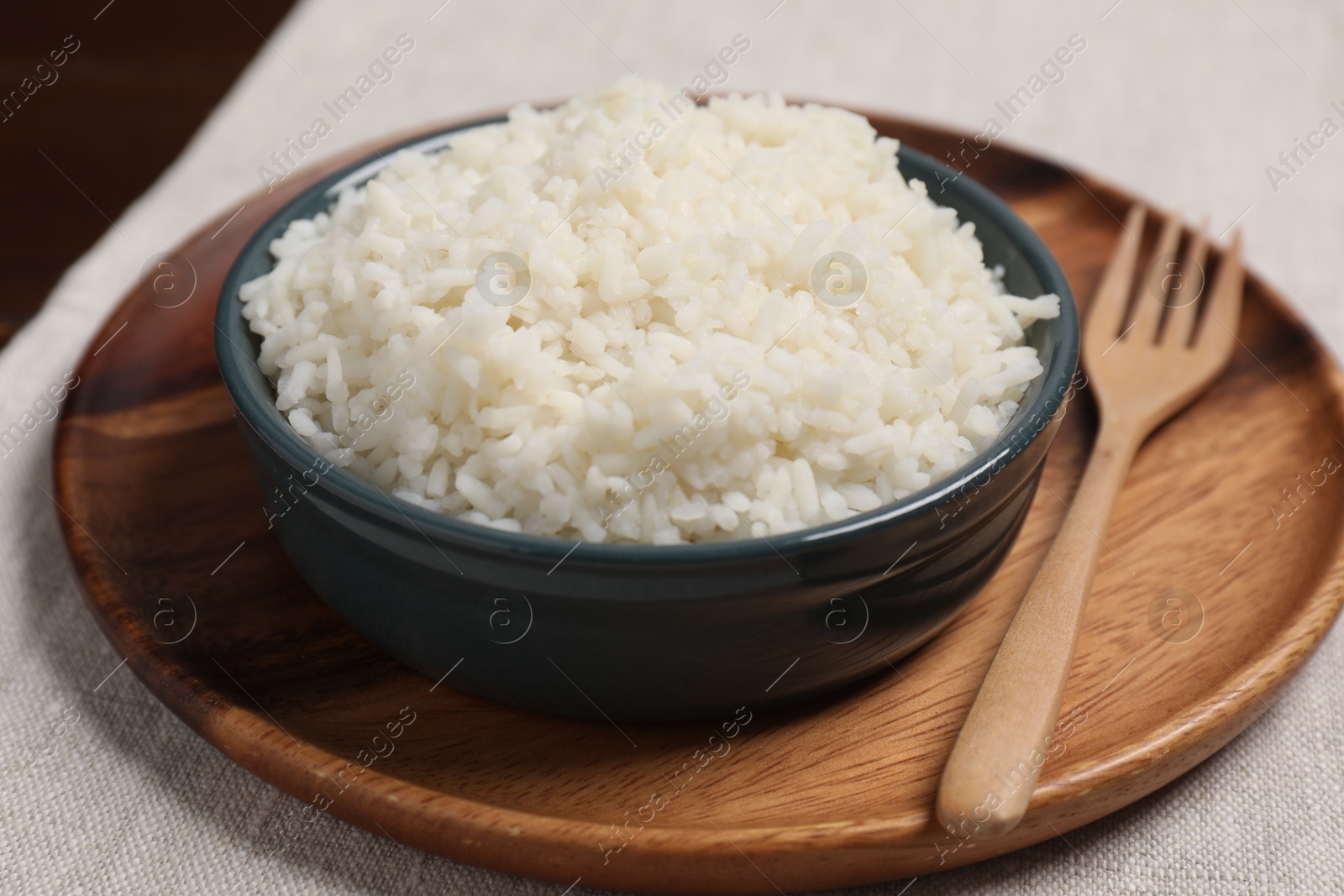 Photo of Delicious boiled rice in bowl on table