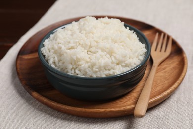 Delicious boiled rice in bowl on table