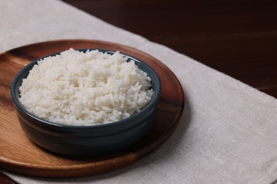 Photo of Delicious boiled rice served on table. Space for text