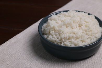 Photo of Delicious boiled rice served on table. Space for text