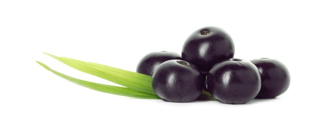 Photo of Fresh ripe acai berries and green leaves isolated on white