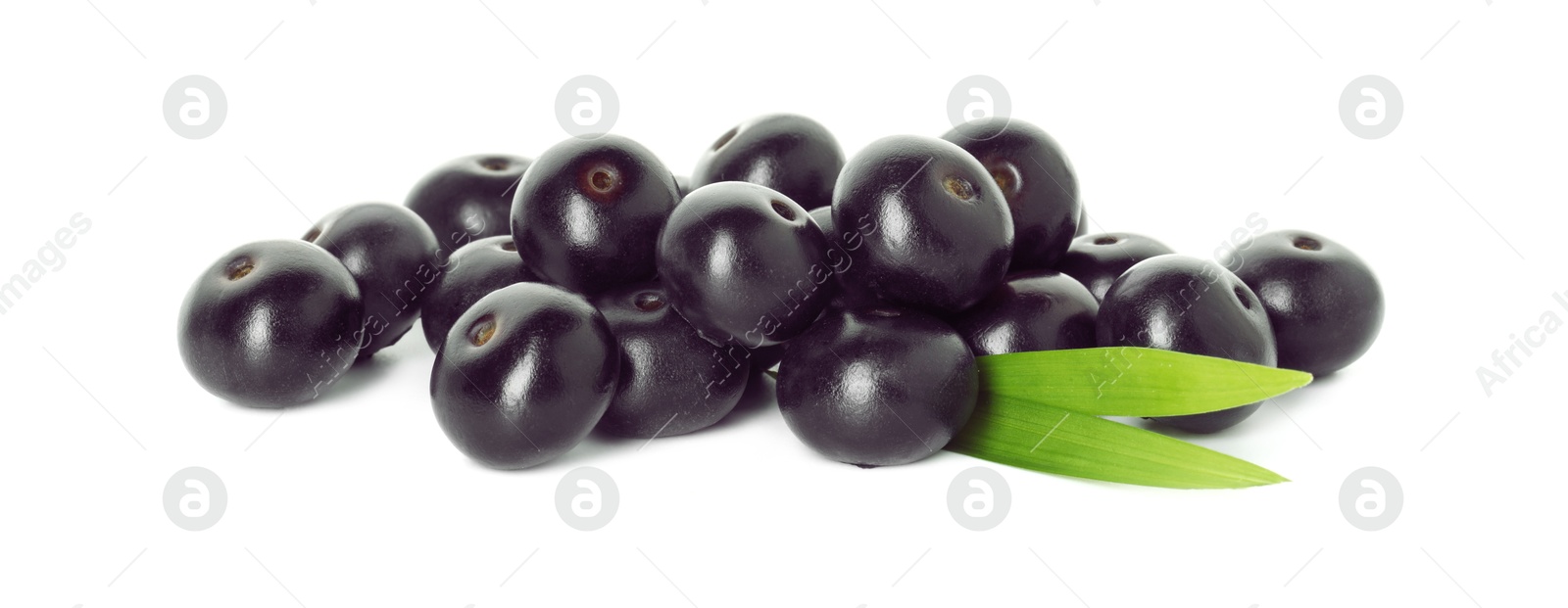 Photo of Fresh ripe acai berries and green leaves isolated on white