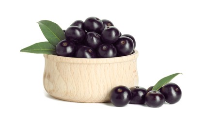 Photo of Fresh ripe acai berries in bowl and green leaves isolated on white