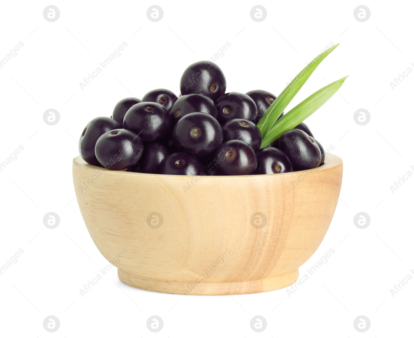 Photo of Fresh ripe acai berries in bowl and green leaves isolated on white