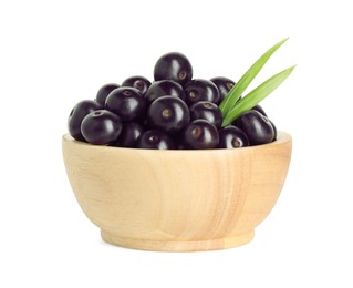 Photo of Fresh ripe acai berries in bowl and green leaves isolated on white