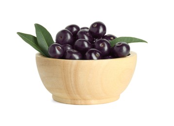 Photo of Fresh ripe acai berries in bowl and green leaves isolated on white