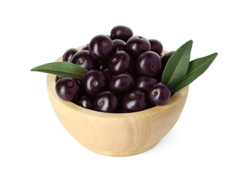 Photo of Fresh ripe acai berries in bowl and green leaves isolated on white