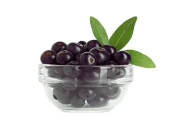 Photo of Fresh ripe acai berries in glass bowl and green leaves isolated on white