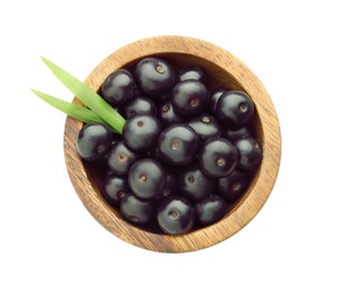 Fresh ripe acai berries in bowl and green leaves isolated on white, top view