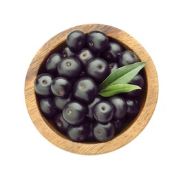 Photo of Fresh ripe acai berries in bowl and green leaves isolated on white, top view