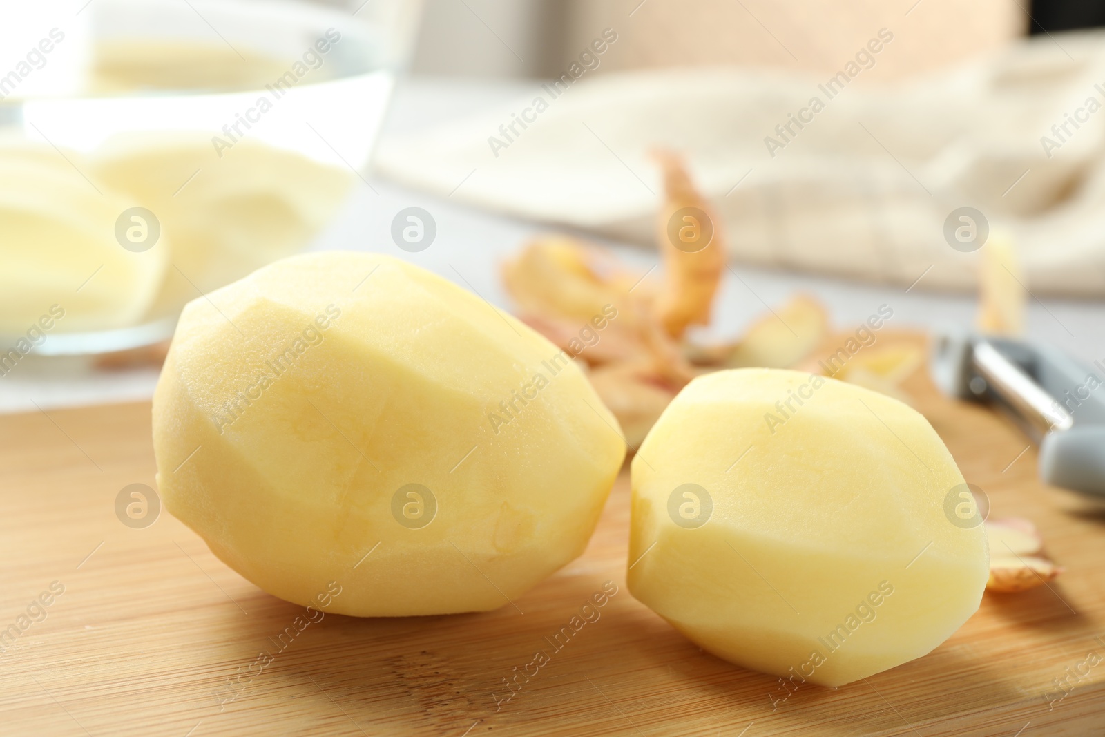 Photo of Peeled fresh raw potatoes on table, closeup