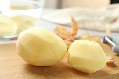 Peeled fresh raw potatoes on table, closeup