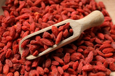 Photo of Dried goji berries and wooden scoop, closeup