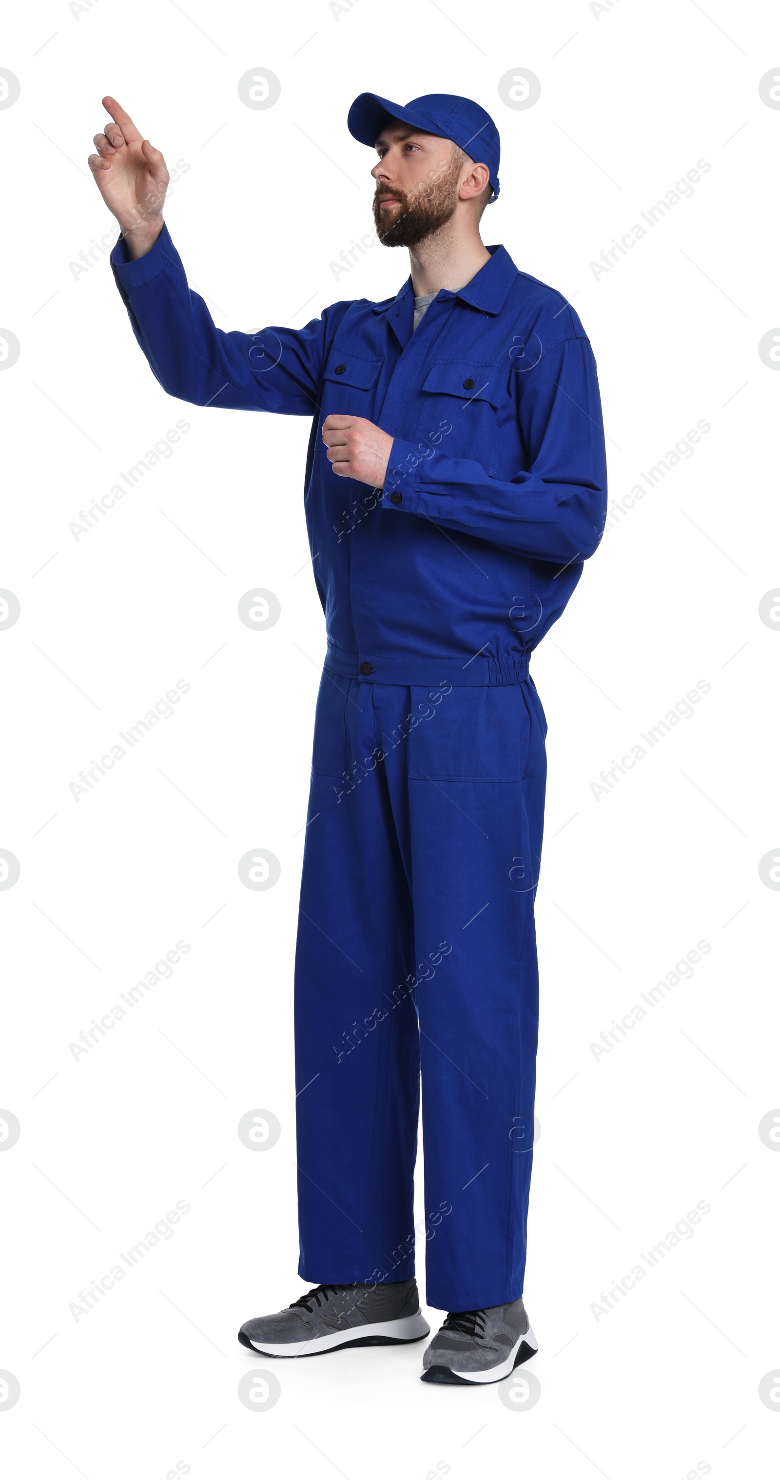 Photo of Professional auto mechanic pointing at something on white background