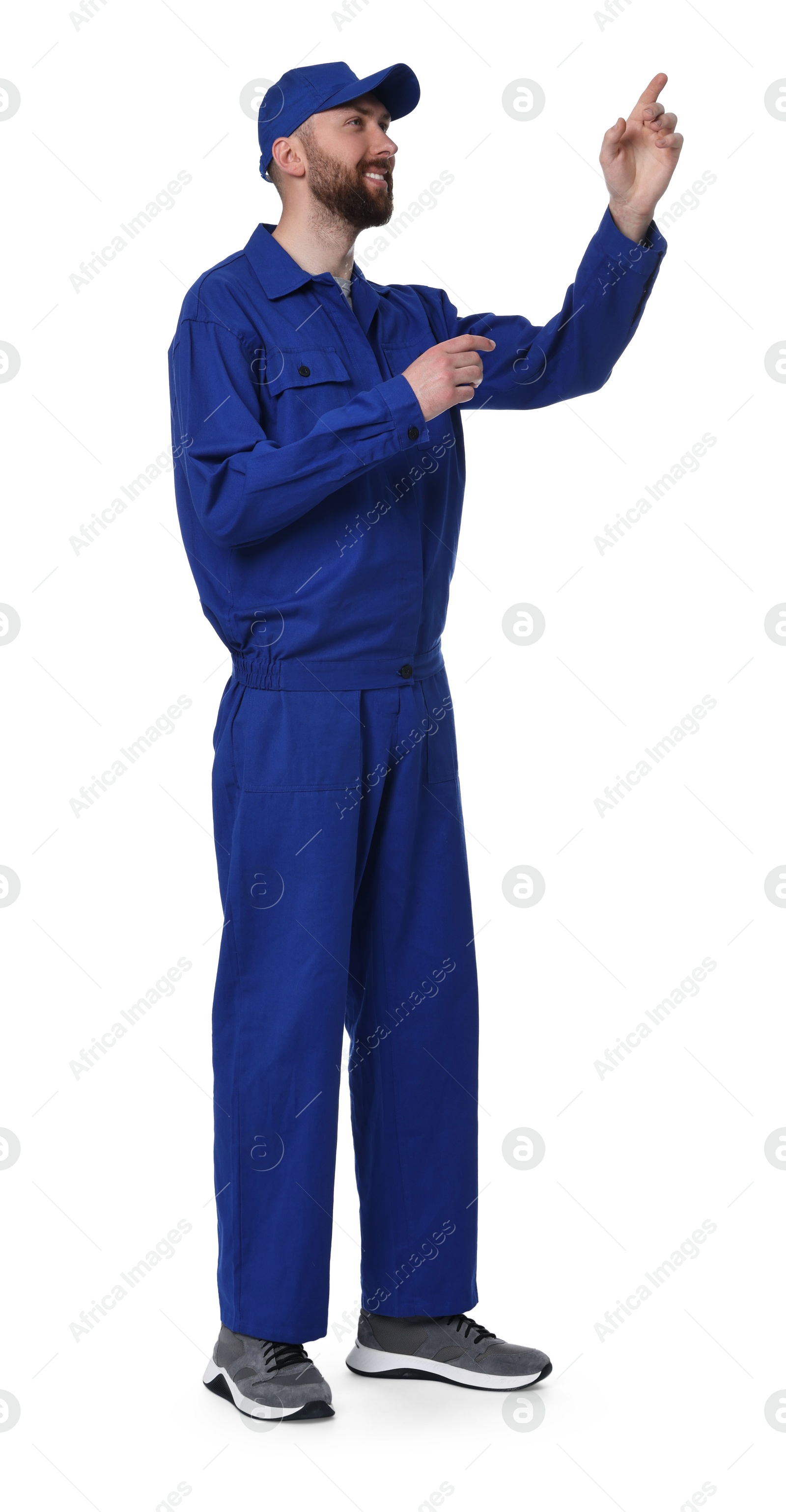Photo of Professional auto mechanic pointing at something on white background
